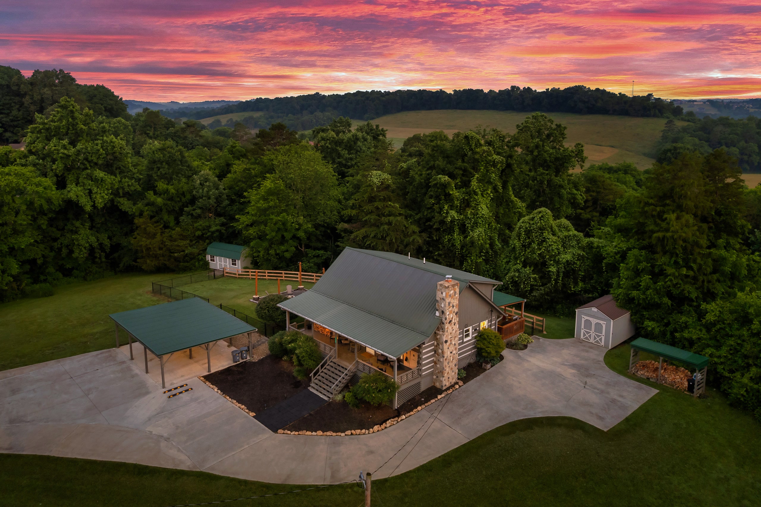 Hillside Haven aerial sunrise view of cabin with stone chimney in Tennessee hills