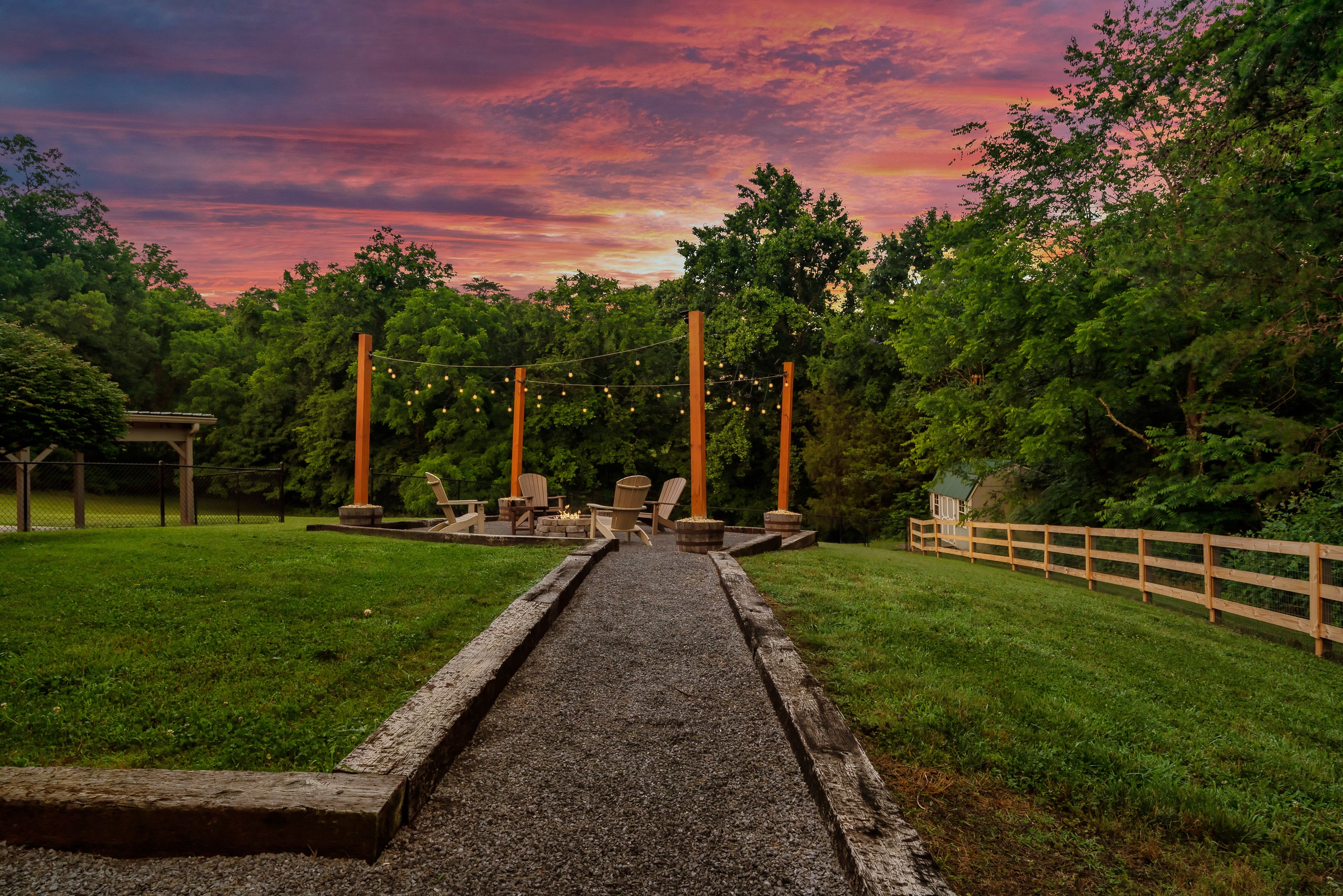 Hillside Haven gravel pathway to fire pit with pergola at sunset in Tennessee