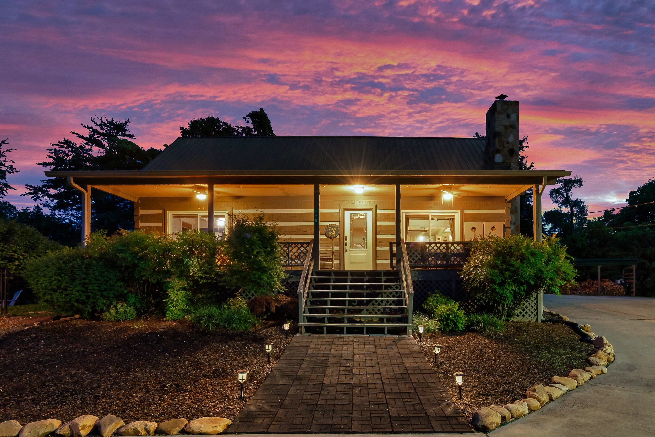 Hillside Haven log cabin exterior at sunset with covered porch in Tennessee Smoky Mountains area