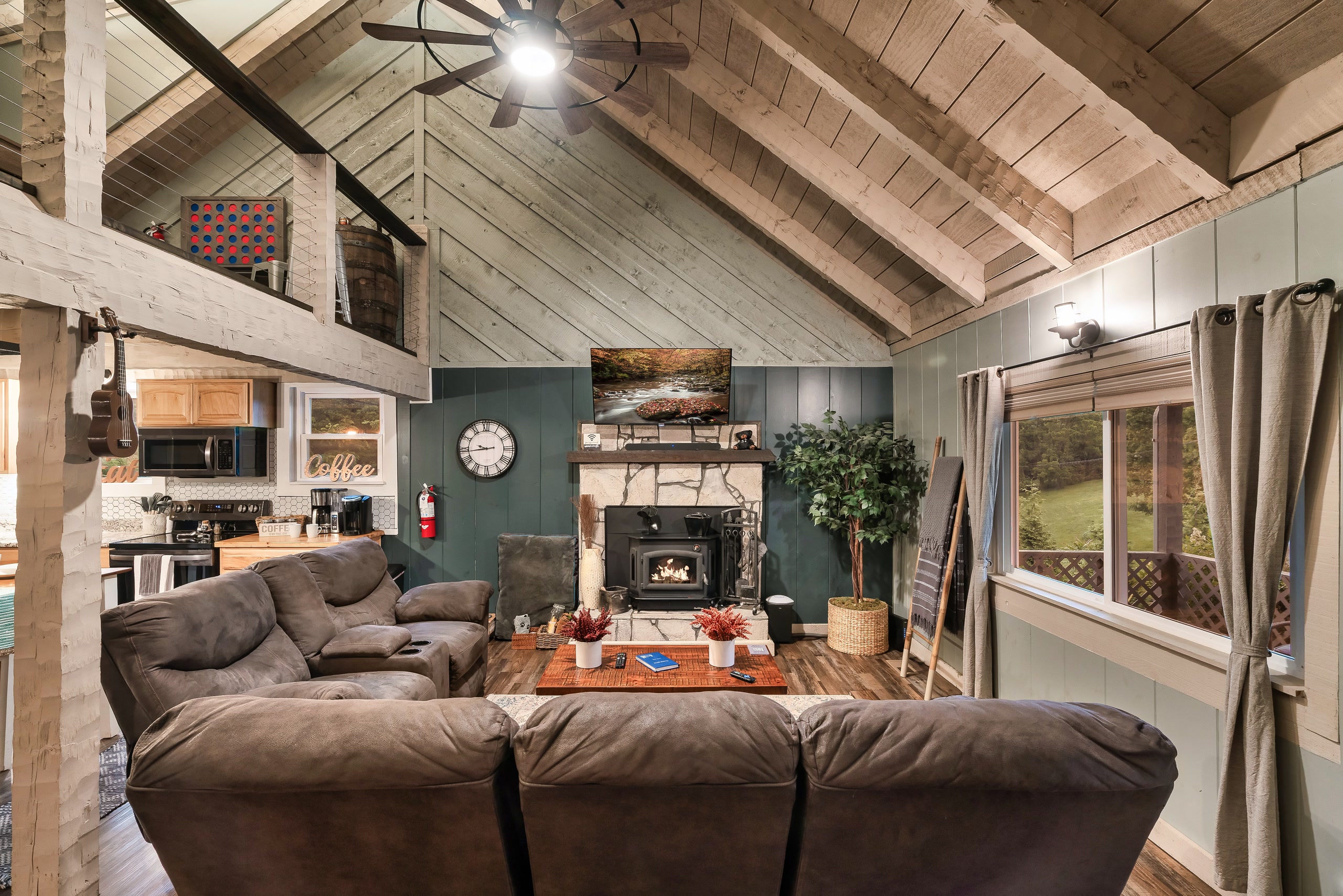 Hillside Haven living room with vaulted ceiling and stone fireplace in Tennessee cabin