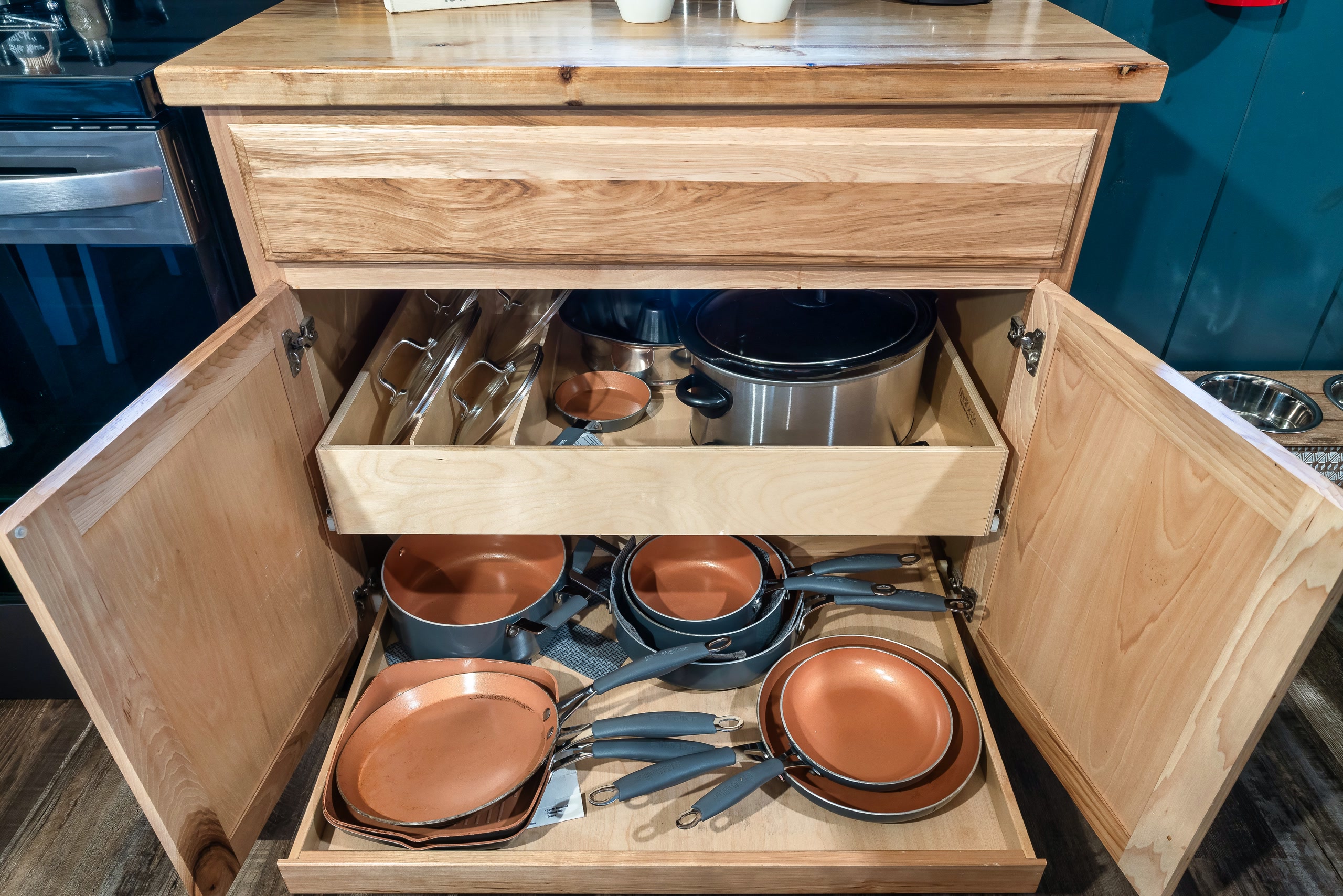 Hillside Haven kitchen cabinet with organized cookware in Tennessee cabin