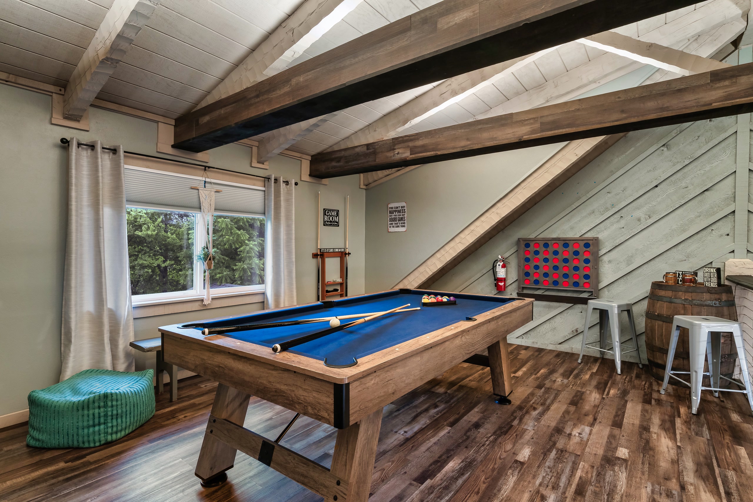 Hillside Haven game room with pool table and vaulted ceiling in Tennessee cabin