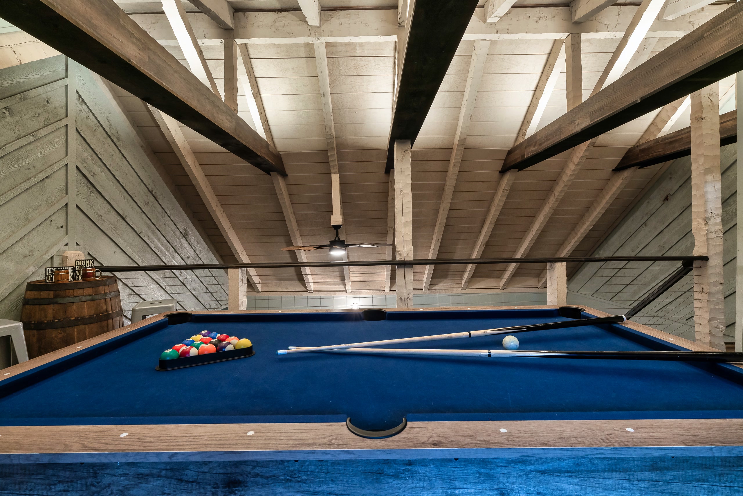 Hillside Haven pool table close-up with loft view in Tennessee cabin game room