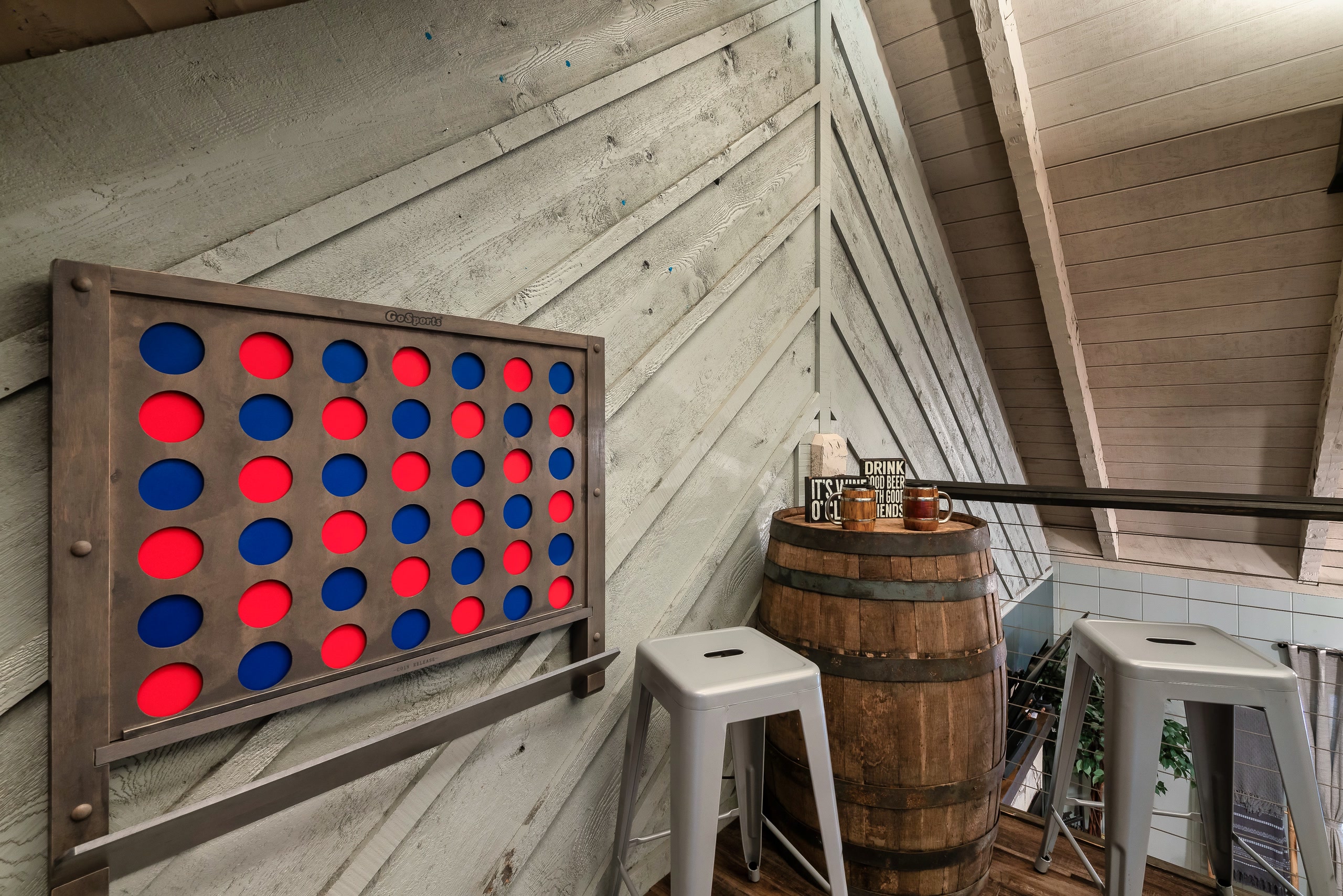 Hillside Haven game area with connect-four board and barrel table in Tennessee