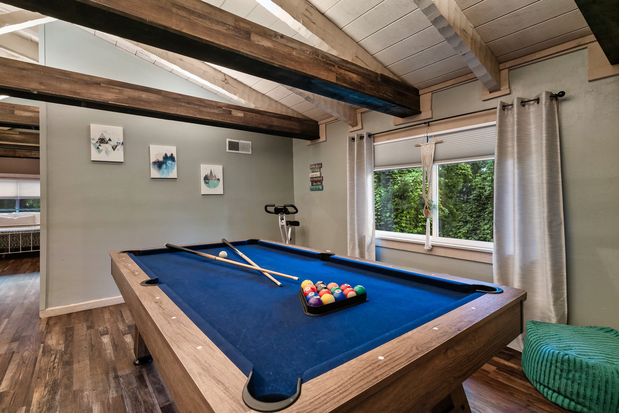 Hillside Haven game room with pool table and large windows in Tennessee cabin