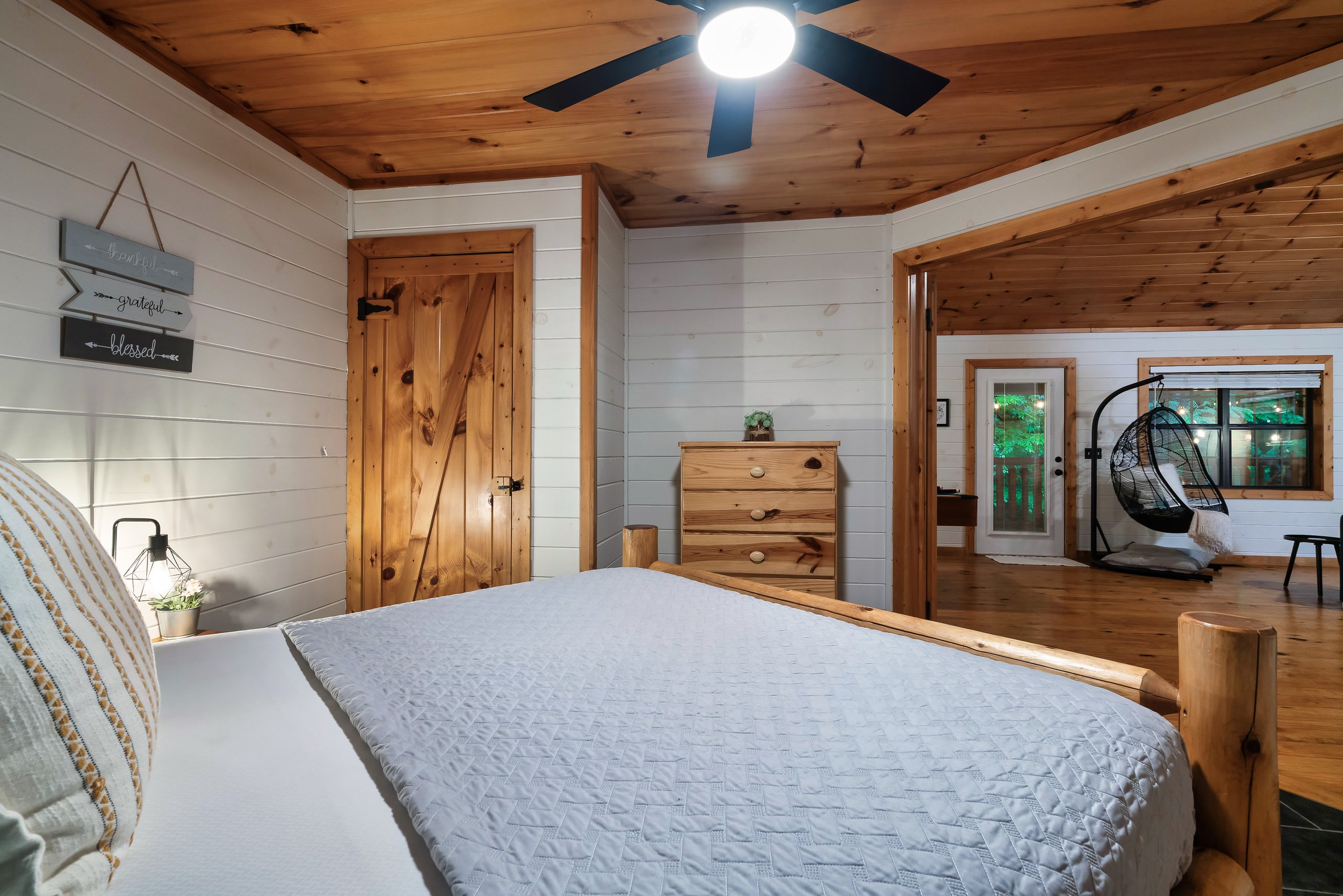 Modern farmhouse bathroom with white shiplap walls and black fixtures at Smoky Creek Hideaway