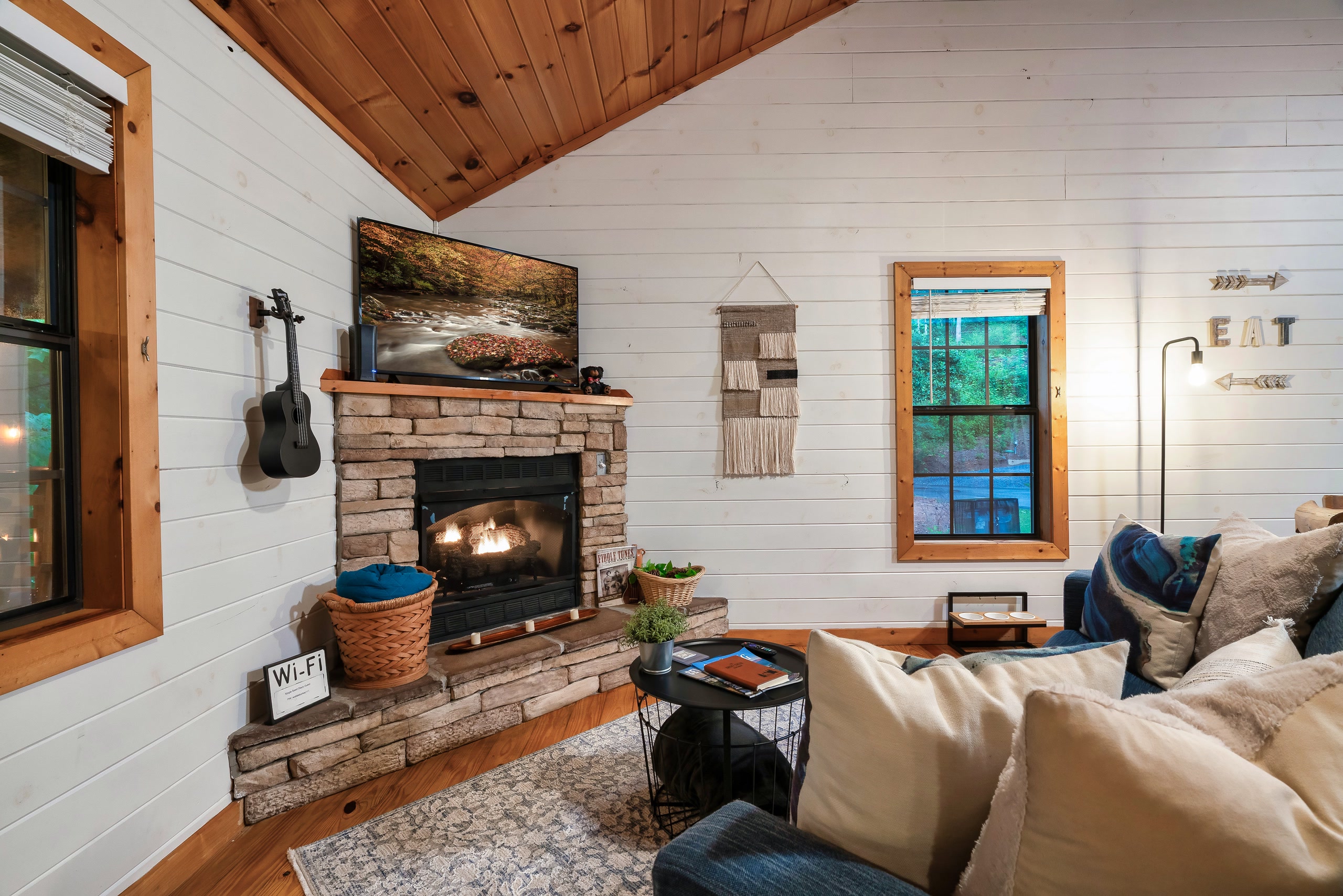 Stone fireplace with guitar and cozy seating at Smoky Creek Hideaway Tennessee