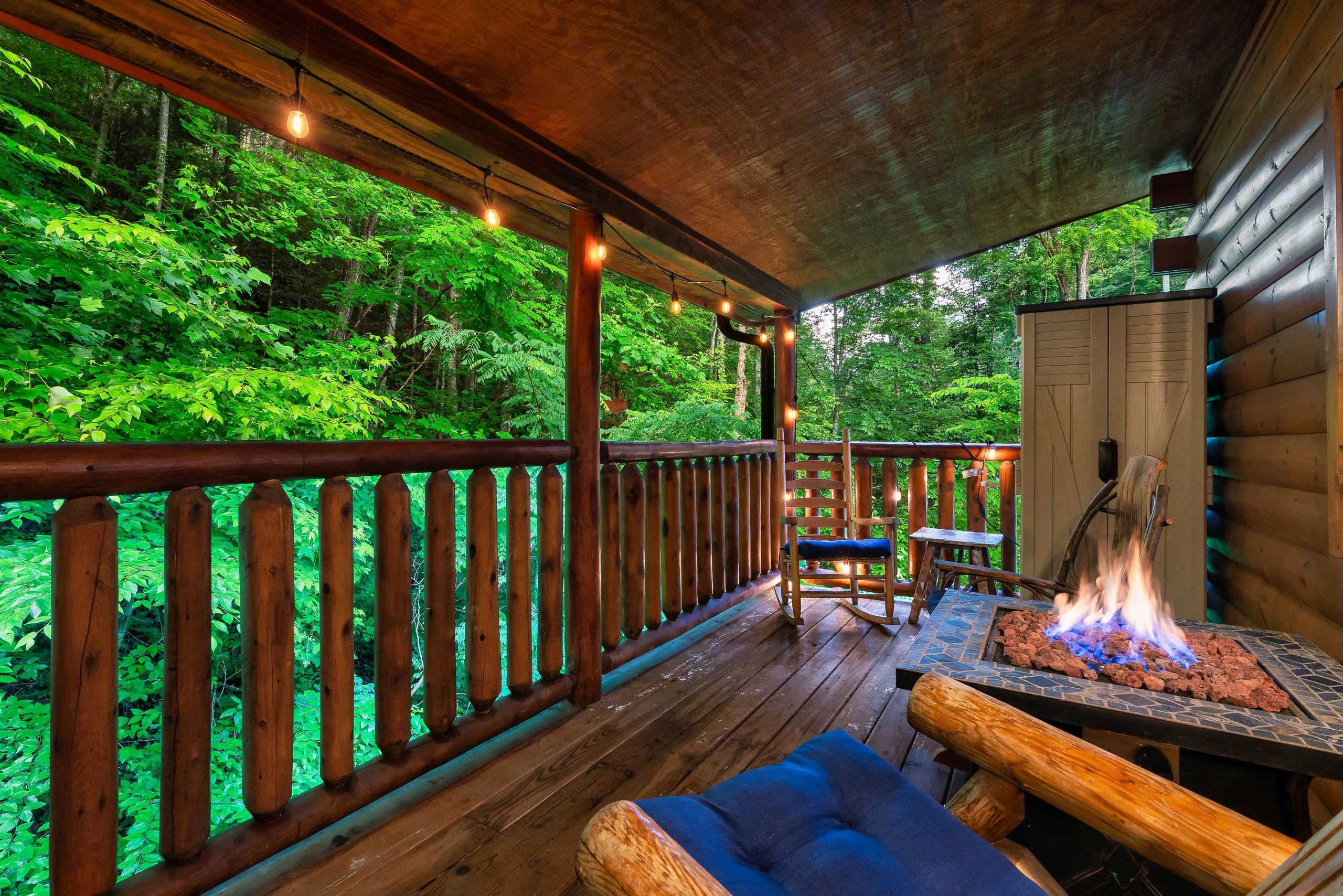 Fire pit seating on covered deck at Smoky Mountains cabin at twilight