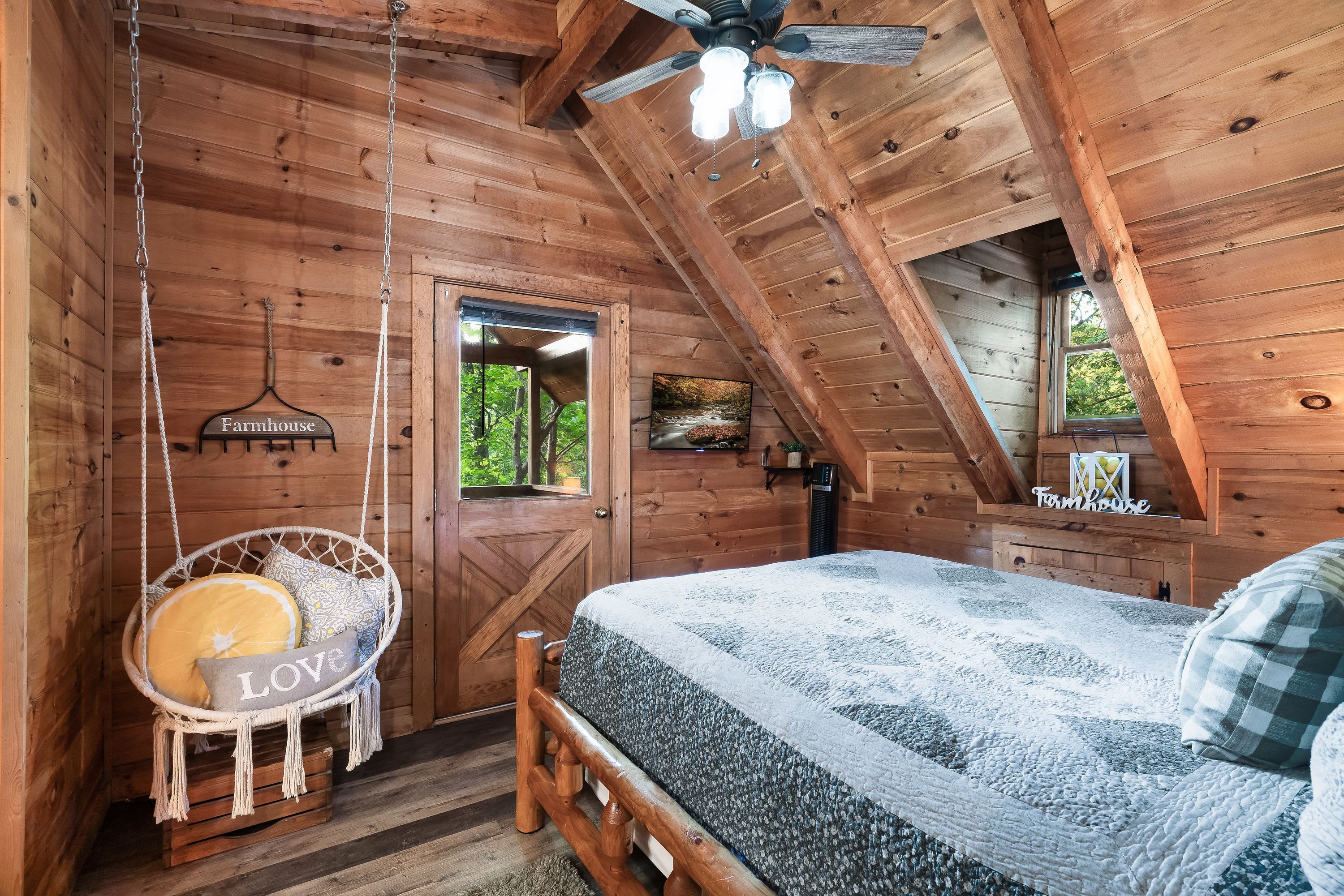 Rustic Rooster bedroom with macrame hanging chair and barn door entrance