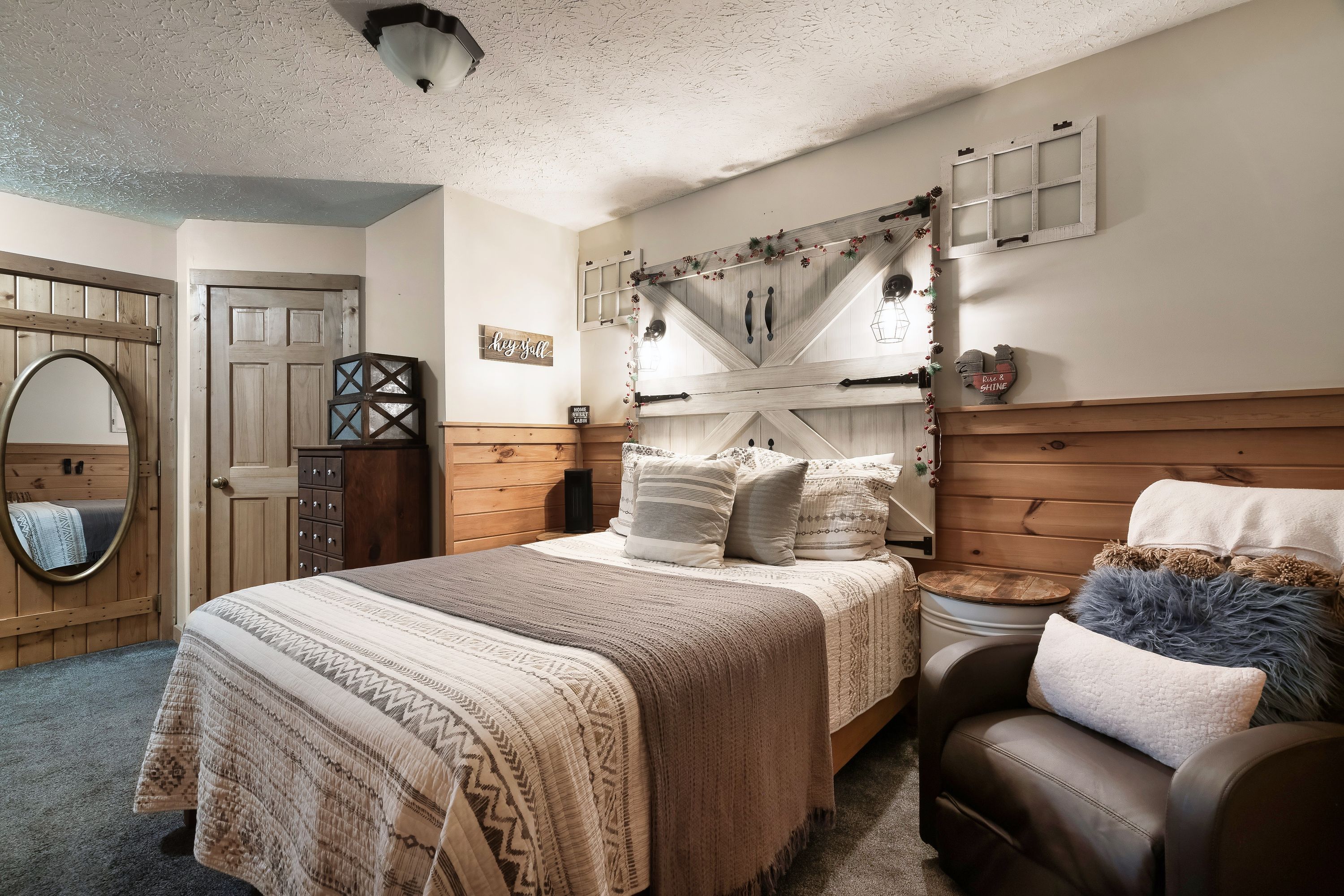 Farmhouse bedroom with leather loveseat at Rustic Rooster Tennessee