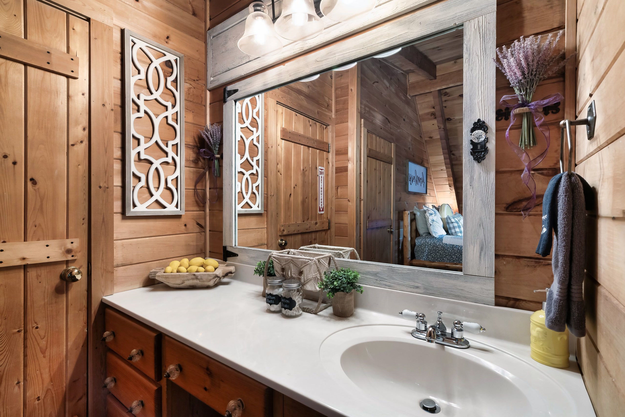 Rustic Rooster bathroom vanity with wood cabinets and framed mirror