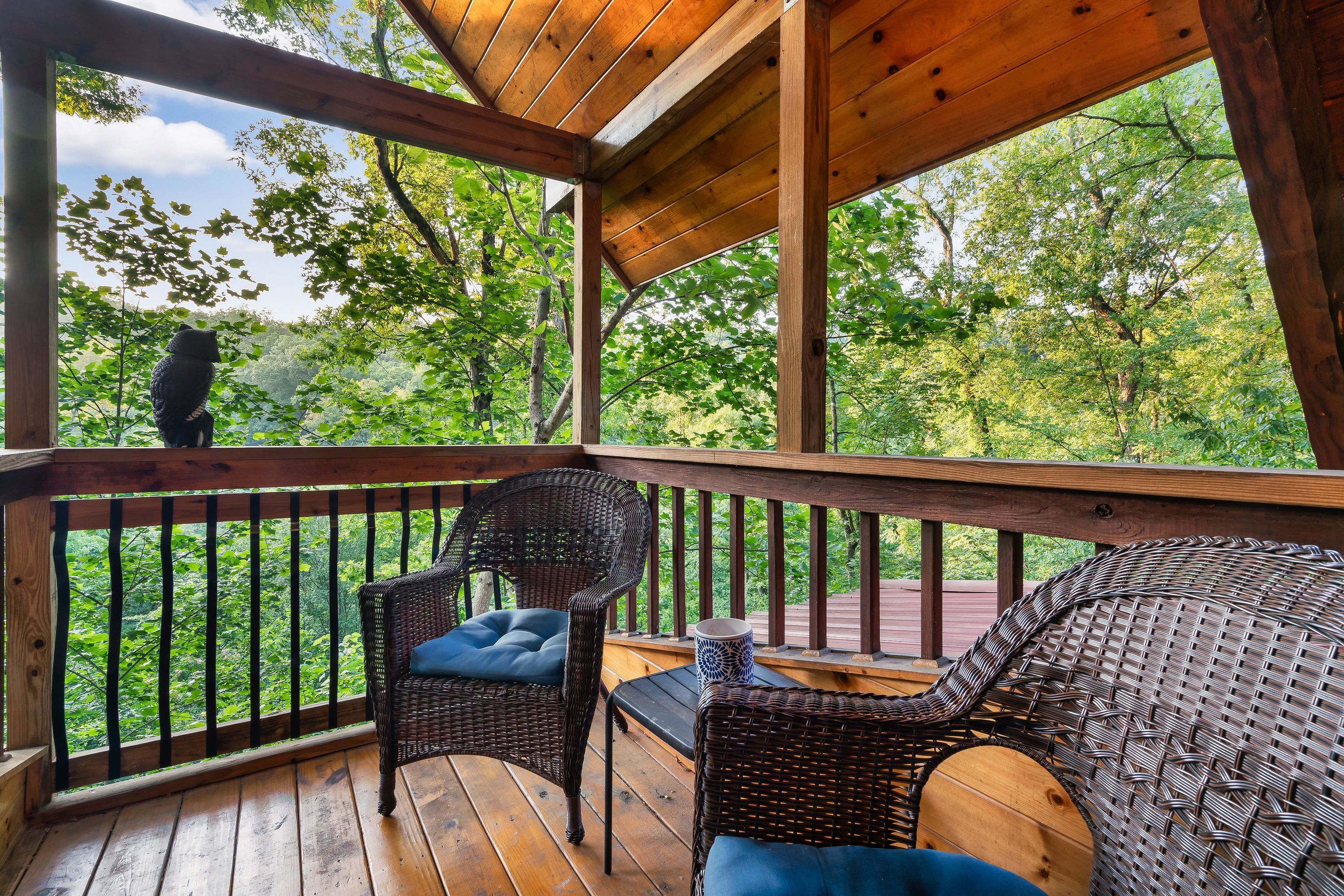 Covered deck corner with forest views at Rustic Rooster cabin