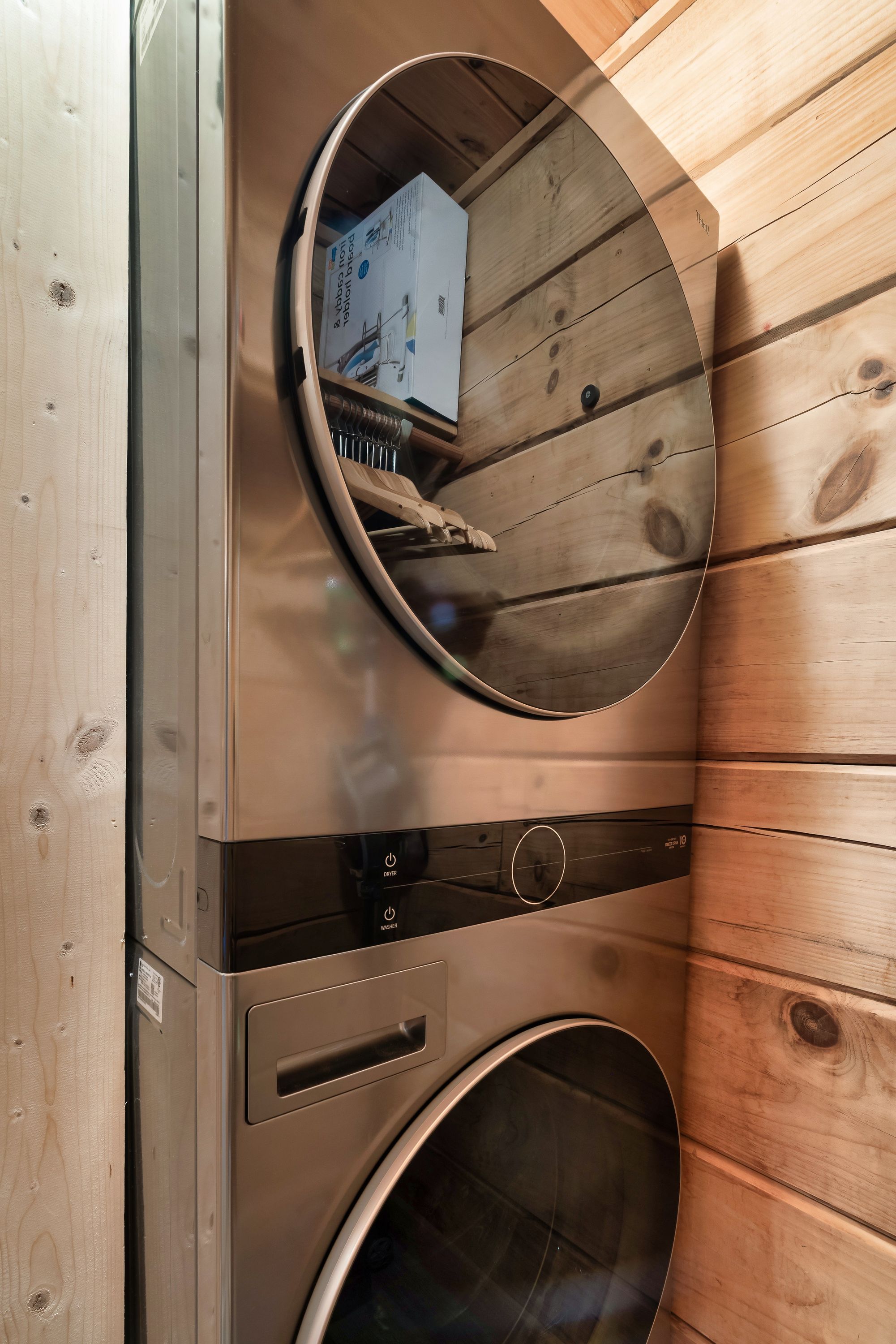 Stacked washer dryer in laundry closet at Rustic Rooster cabin