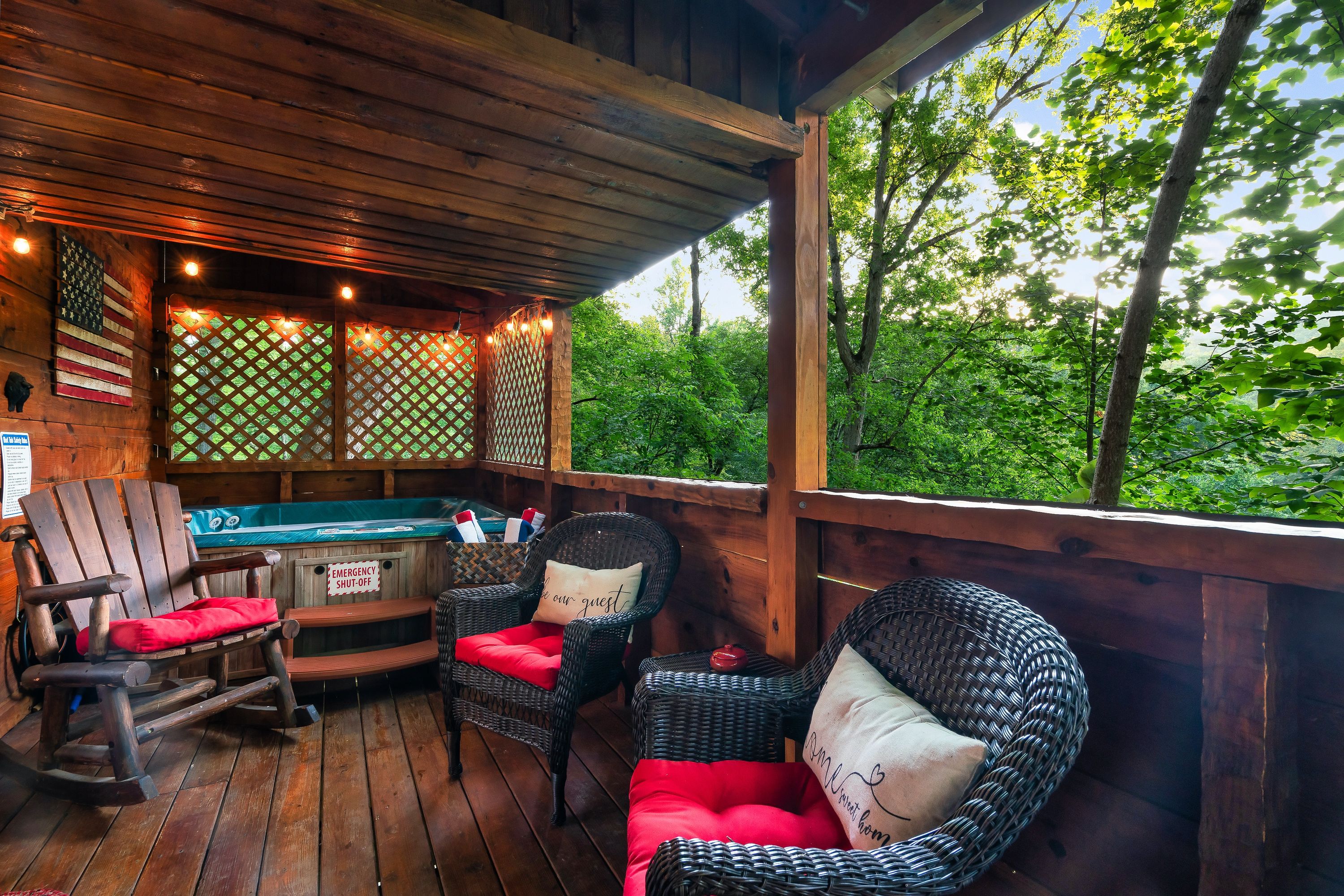 Covered deck with hot tub and seating at Rustic Rooster cabin Tennessee