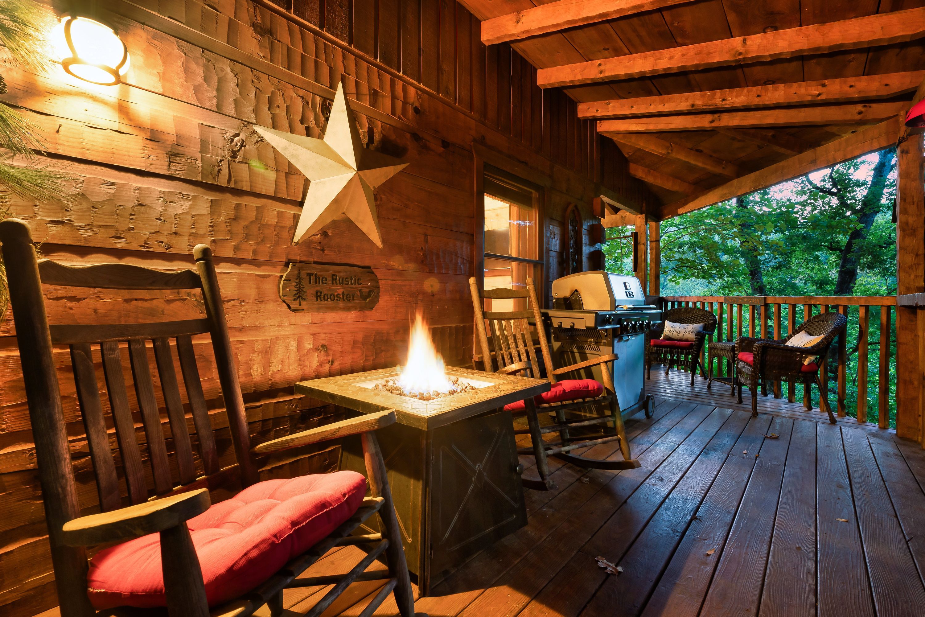 Rustic Rooster deck with fire pit table and rocking chairs at dusk
