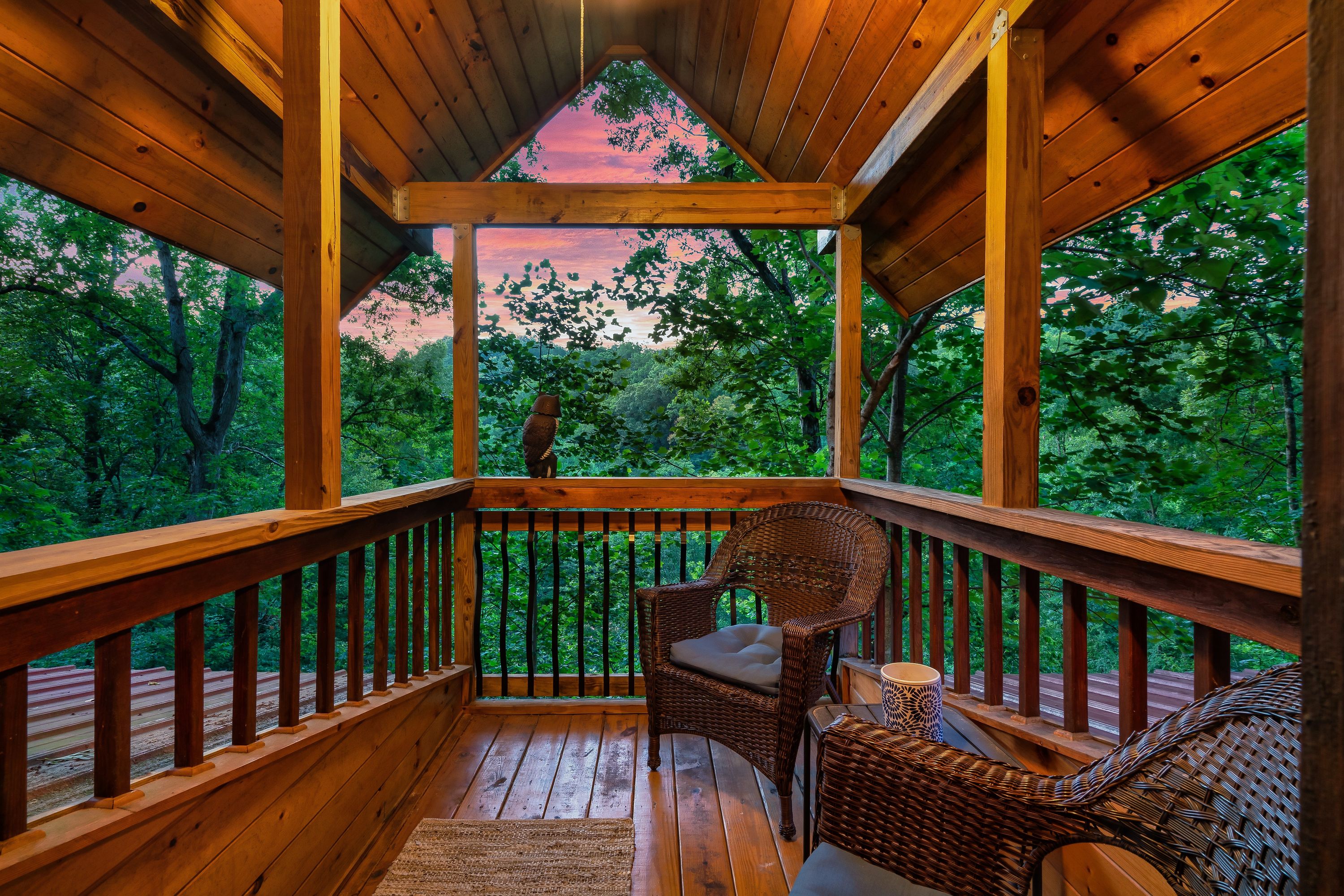 Covered deck with forest views at Rustic Rooster Tennessee cabin